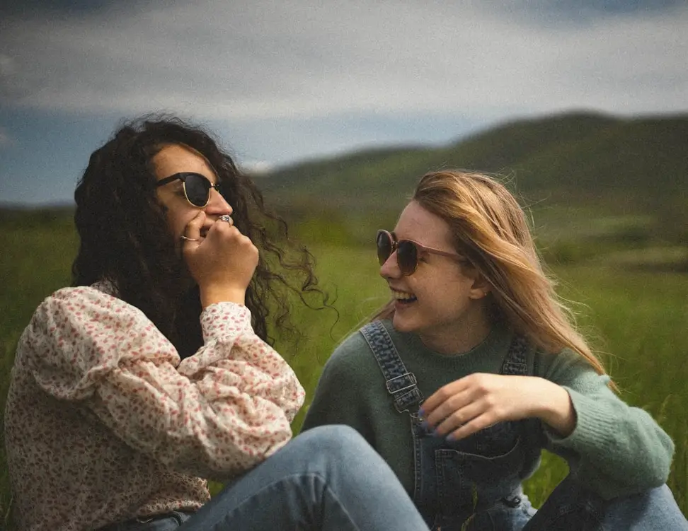 Two friends laughing outdoors