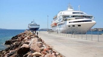 View of a ferry docked at Lavrio Cruise Terminal, with blue skies above.