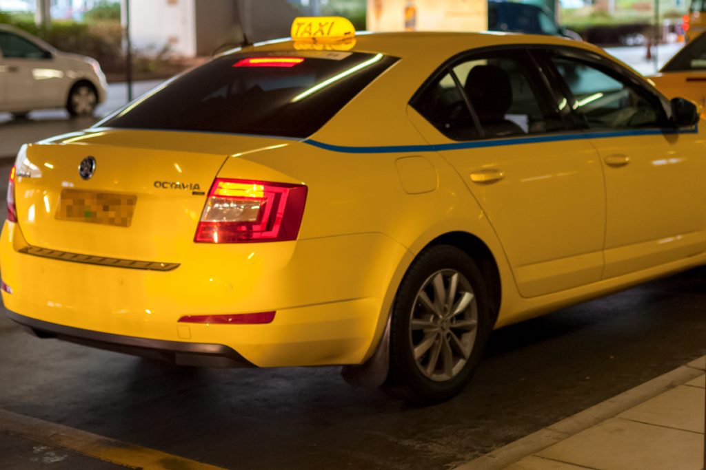 Athens Airport yellow taxi parked in the taxi rank outside Arrivals.