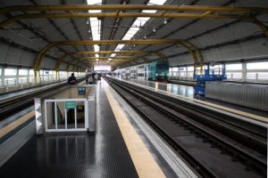 View of the inside of Fiumicino Airport train station, with a platform with tracks either side.