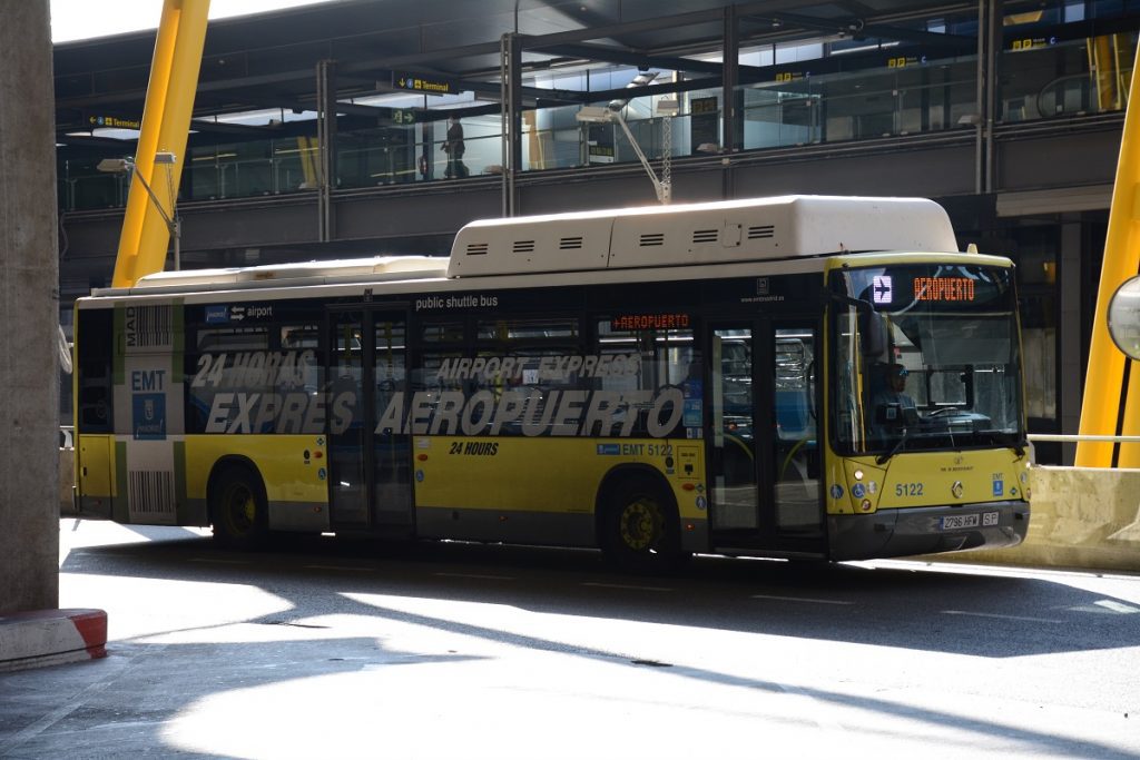 A yellow Madrid Airport Express bus departing from the airport.