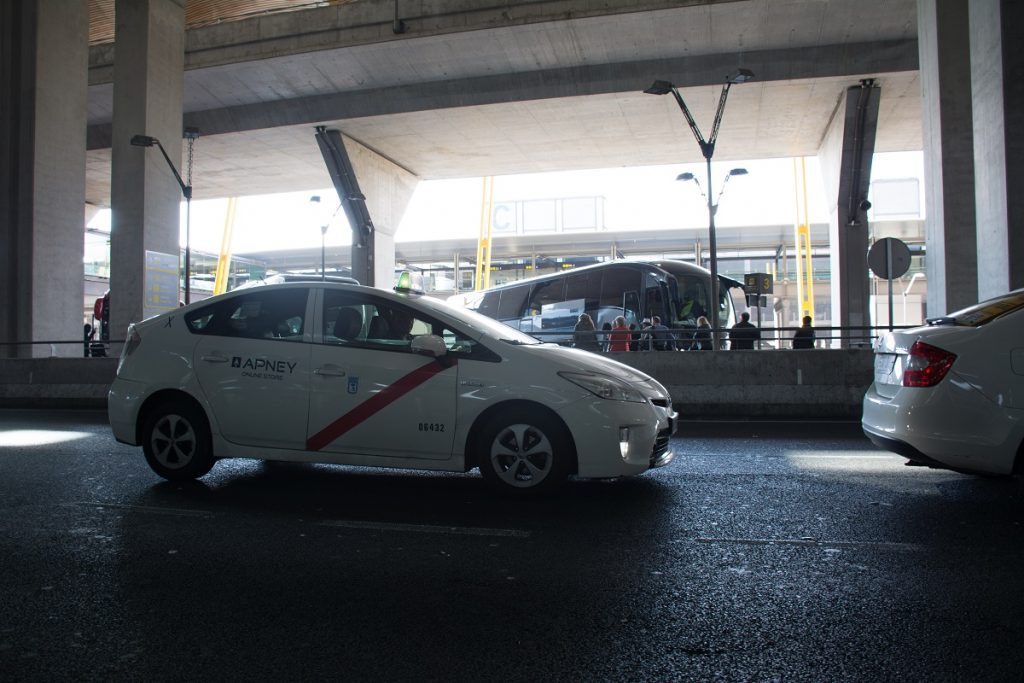 A white Madrid Airport taxi