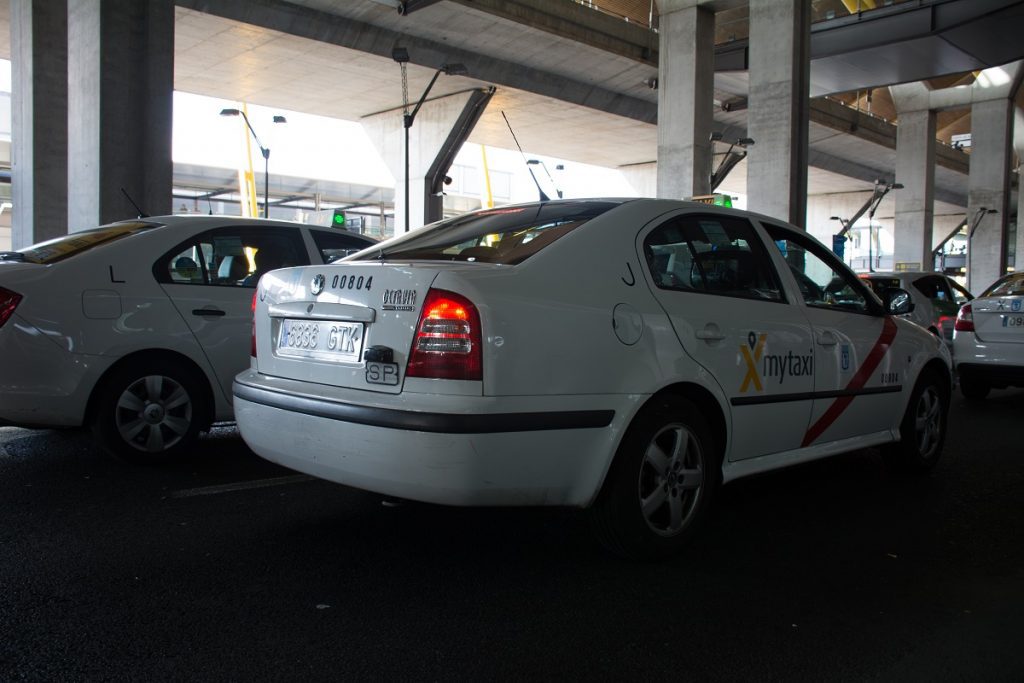 A white Madrid Airport taxi