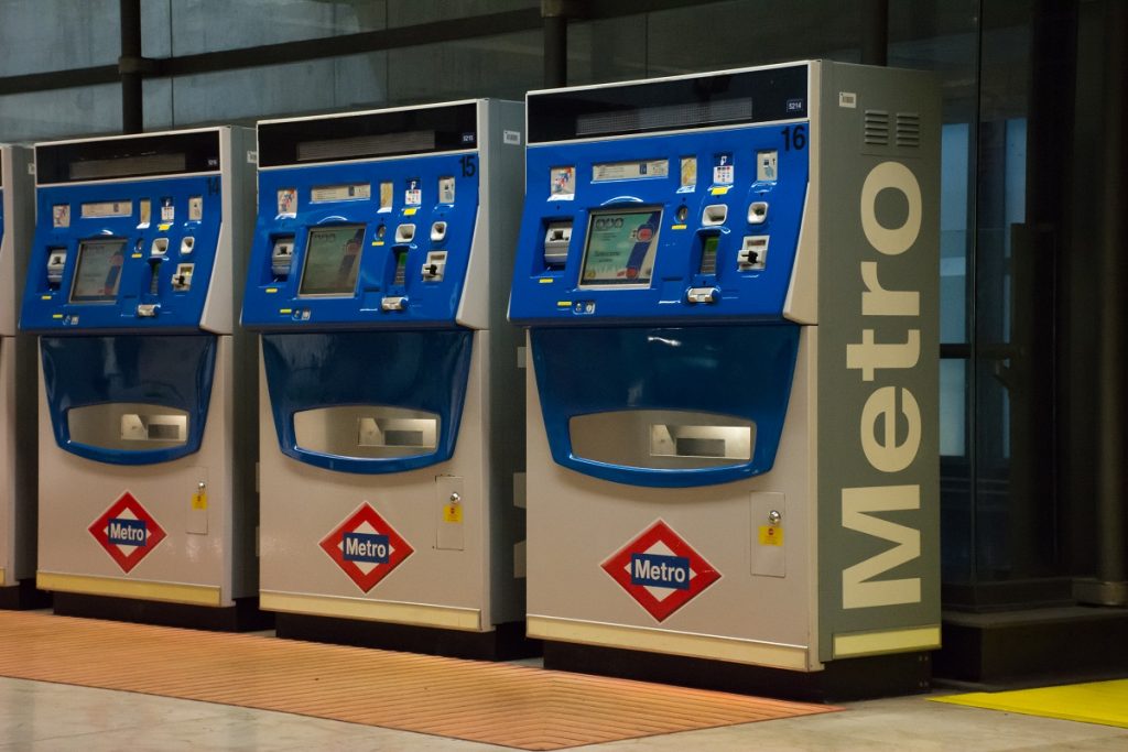 Madrid Airport blue automated metro train ticket machines.