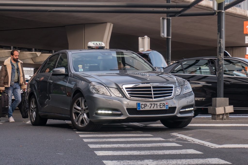 A silver Orly Airport taxi.