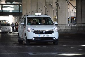 Madrid airport white minivan taxi departing from the airport