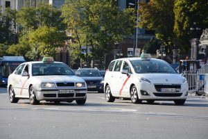 White Madrid white taxis driving on the street.