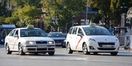 White Madrid white taxis driving on the street.