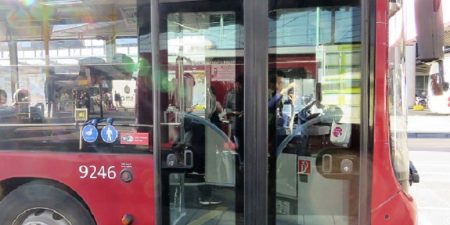 A red Connexxion bus 397 in Amsterdam waiting on the platform.
