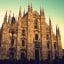 View of the Duomo in Milan City Centre, with blue skies above.
