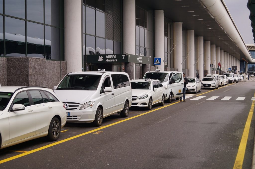 Milan Airport taxis lined up offering rides from Milan Malpensa Airport to city center