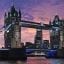 London bridge towers under a pink and purple sunset
