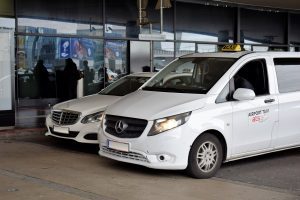 Vienna Airport taxi (Minivan) A white Vienna Airport taxi (Minivan) parked outside Vienna Airport.