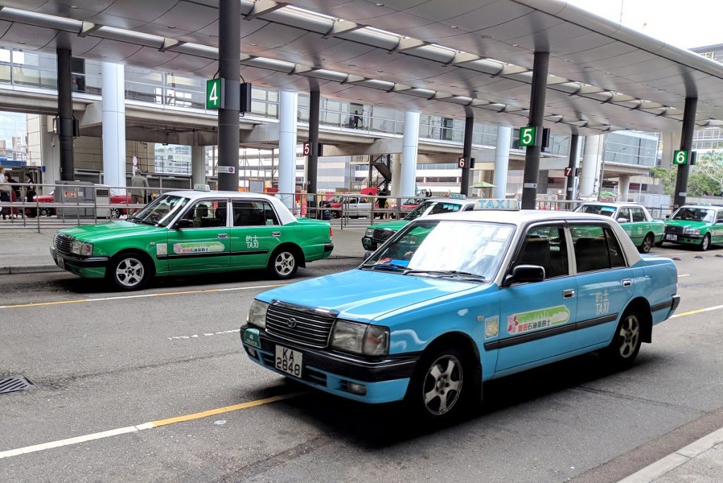 Lantau-blue and New Territories-green Hong Kong airport taxis lined up
