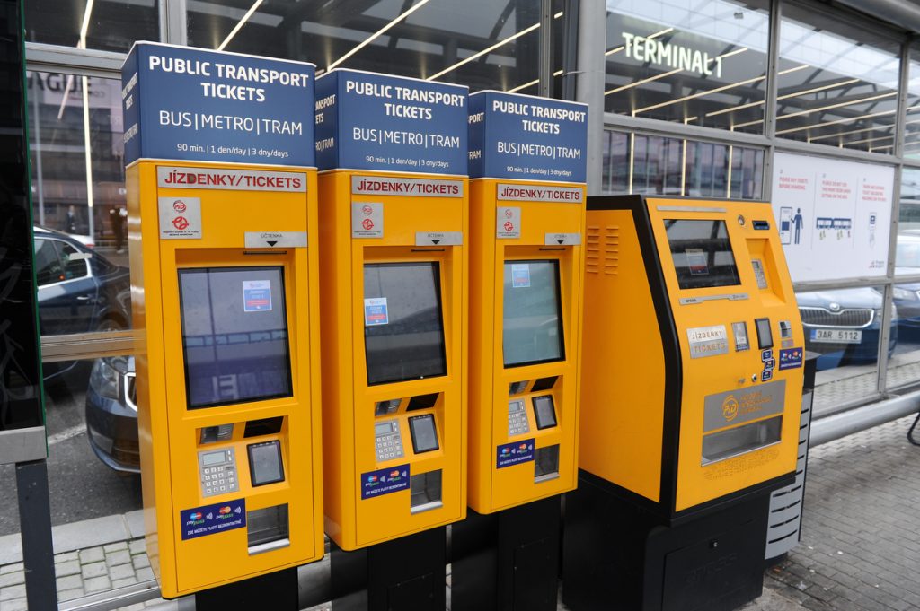 Bright yellow ticket vending machines outside of terminal 1 at Prague Airport.
