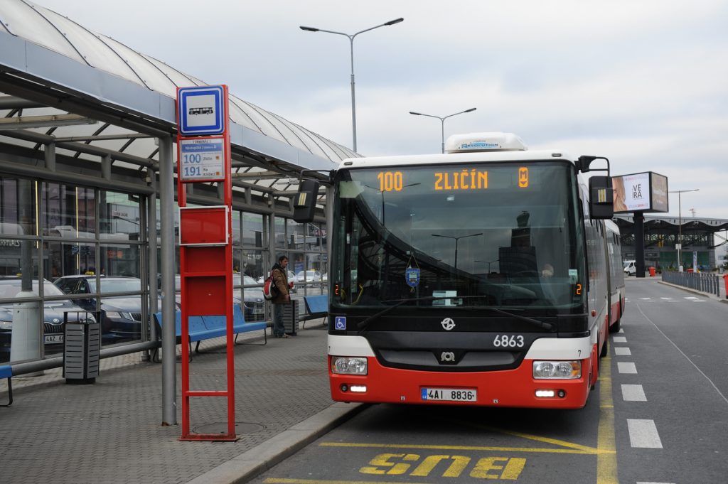 Public bus No. 100 waiting on at the bus stop outside of the terminal.