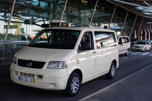 Lisbon airport white minivan taxi offers a transfer from lisbon airport to cascais