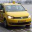 A yellow Budapest taxi driving on a street in Budapest city center
