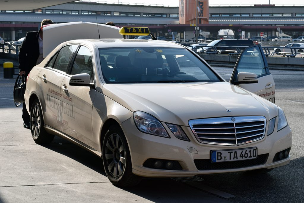 An ivory Berlin taxi parked at the airport.