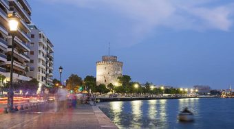 Thessaloniki waterway and buildings at night.