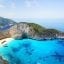 Aerial view of Shipwreck Beach, a white-sand beach with turquoise blue waters and cliffs.