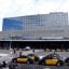 The entrance to Sants Railway Station in Barcelona with yellow and black taxis lined up out front.