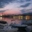 Sunset over Kalamata waters with boats. Enjoy this relaxing view after arranging your transfer from Kalamata Airport to the city center with Welcome Pickups.