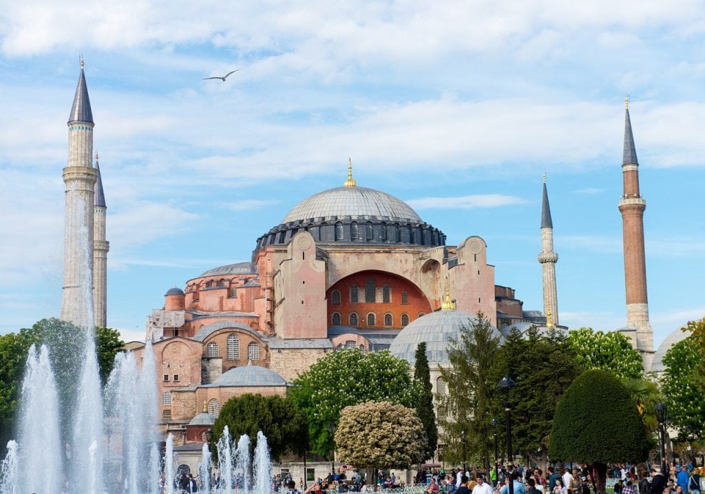 Daytime view of Hagia Sophia in Istanbul, framed by minarets and greenery with a fountain in the foreground—an iconic landmark along the route from Istanbul Airport to SAW Airport.