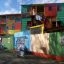 homes painted with primary colors in squares under a blue sky