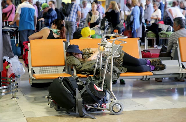 airport sleeping passenger