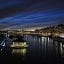 night view of lights and a boat under a very dark sky