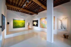 minimal interior or art gallery with colourful works of art hanging on the walls