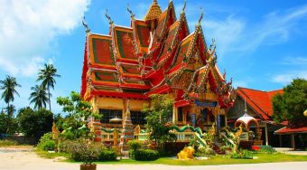 A green and gold ornate temple in Bangkok