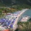 beachfront in Pattaya covered with beach umbrellas and boats in the water