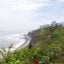 View of Miraflores coastline, with lush greenery behind a beach lining the water. Take a taxi in Lima and start exploring as soon as you land