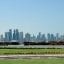 A view of Doha from Doha Airport with ships in the bay and skyscrapers behind.