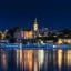 Belgrade city skyline at night across the waterway.