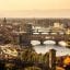 the bridges and buildings of Florence under a hazy sky