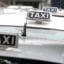 white taxi with black and white Taxi sign on roof of a florence taxi