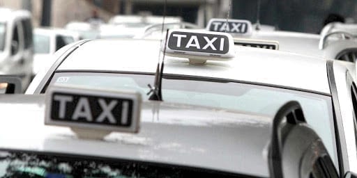 florence taxi white taxi with black and white sign on roof in florence