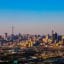 View of Johannesburg city's skyline, with blue skies above.