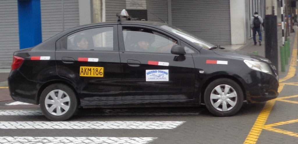 Lima Aiprort taxi, Peru - Welcome Pickups Side view of a black Lima taxi stopped on a zebra crossing.