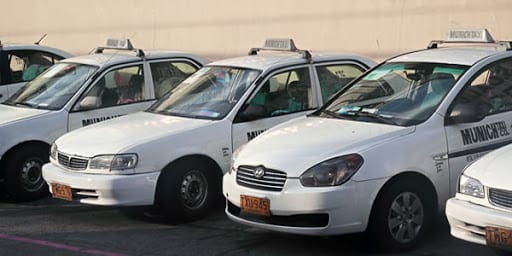 White Munich taxis lined up next to each other.