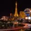 Las Vegas Strip at night with the Eiffel Tower in view.