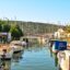 A canal in Bodrum flanked by fishing boats on either side.