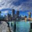 Boston waterway and skyline under a cloudy blue sky