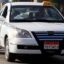 white car with black and white checked strip on the side and yellow taxi sign on roof in Cairo egypt