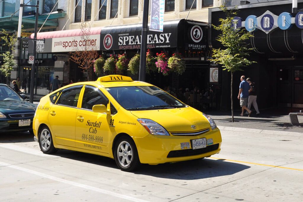 A yellow taxi cab on the street in Vancouver Canada