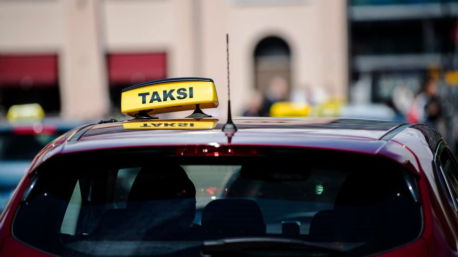 helsinki taxi yello taxi sign on top of red cab in helsinki finland