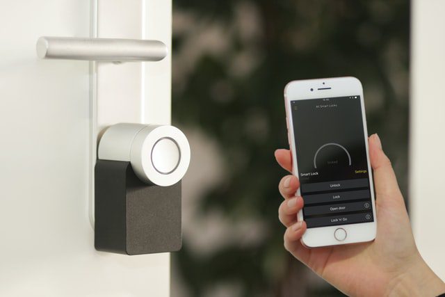 iphone with app on screen unlocking digital door lock